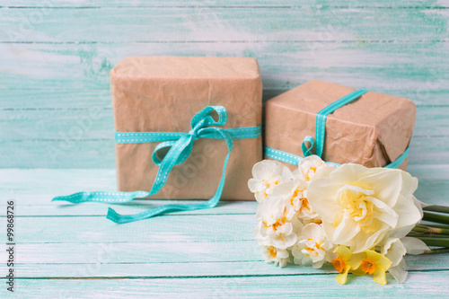 Festive present boxes and flowers on turquoise painted wooden