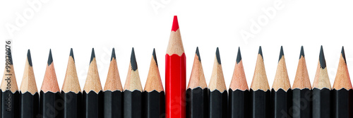 Row of black pencils with one red pencil in middle