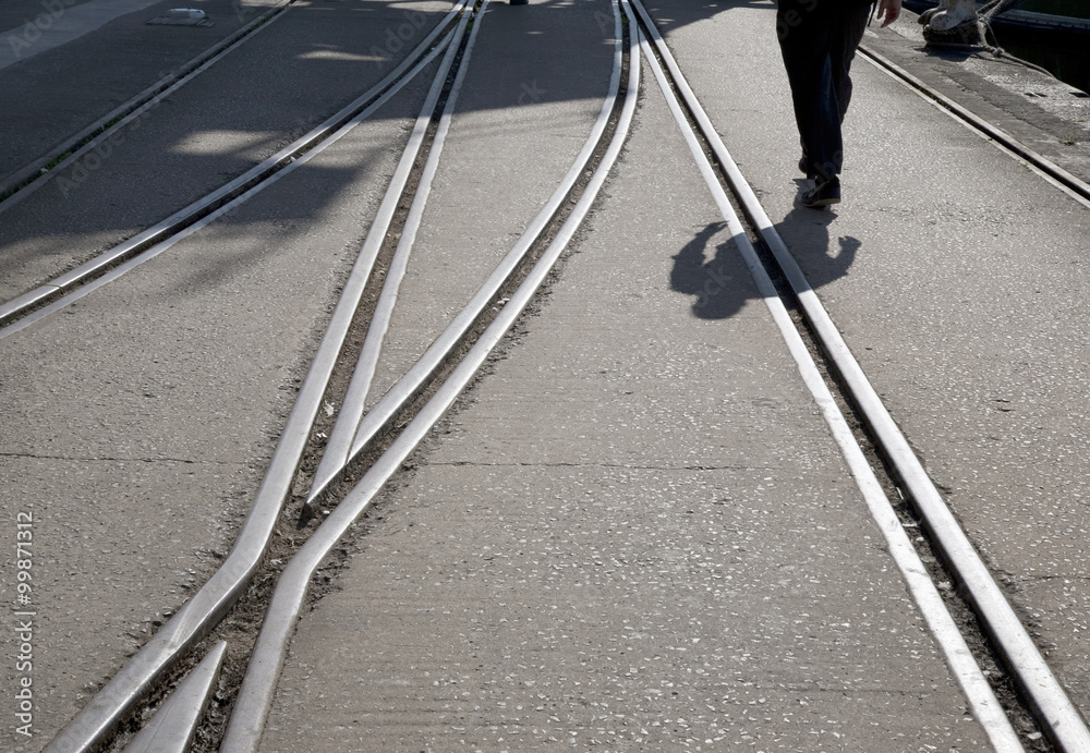 Railway Track and Man Walking into the Distance