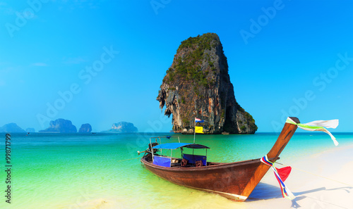 Exotic tropical beach and traditional thai boat