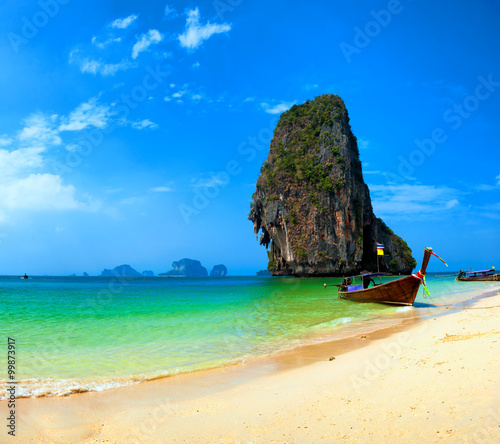 Thailand beach and tropical island. Traditional boat on sea shore