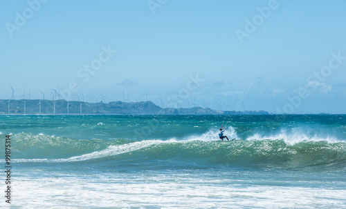 Kite surfer athlete on big sea wave. Extreme sports