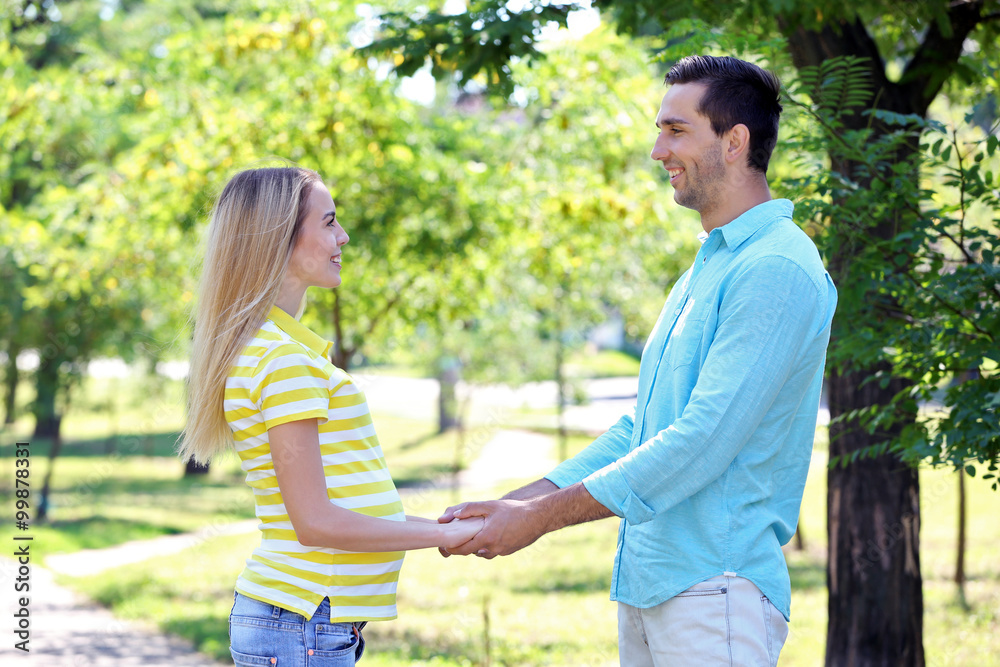 Young pregnant woman with husband in park Young pregnant woman with husband in park