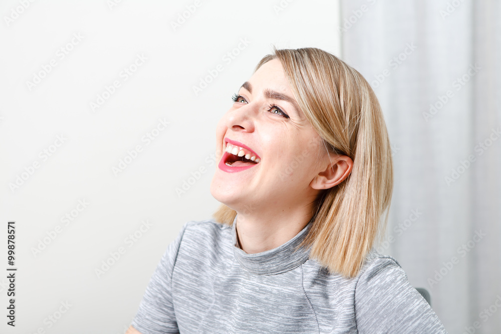 Young smiling business woman sitting at her workplace in office Young smiling business woman sitting at her workplace in office