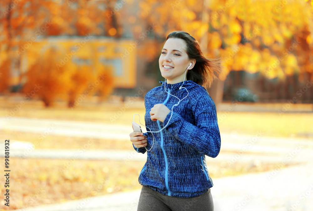 Fototapeta premium Young woman jogging at park