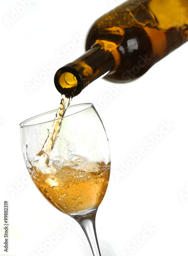 White wine pouring in glass  isolated on white