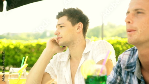 Two young friends in summer day are chattering    photo