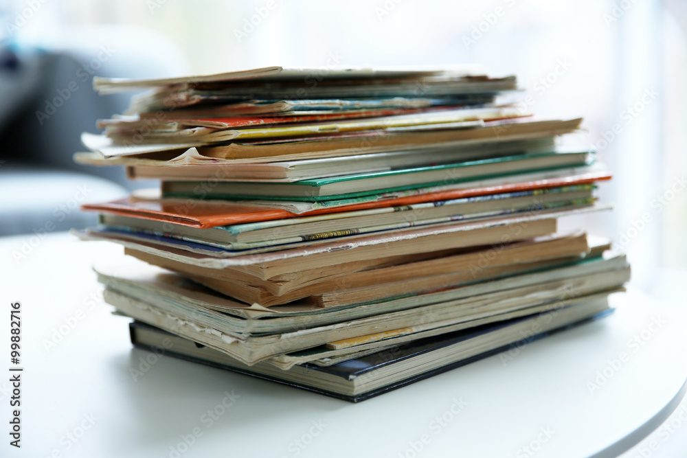 Pile of old books on white table Pile of old books on white table