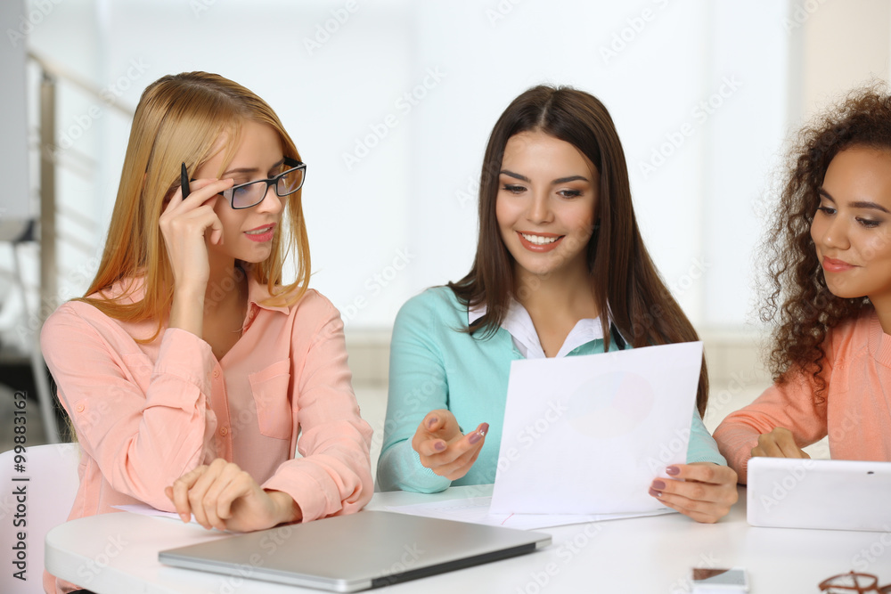 Young business people discussing a new project at the meeting in a conference room Young business people discussing a new project at the meeting in a conference room
