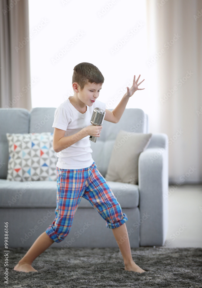 Little boy singing with a microphone at home Little boy singing with a microphone at home