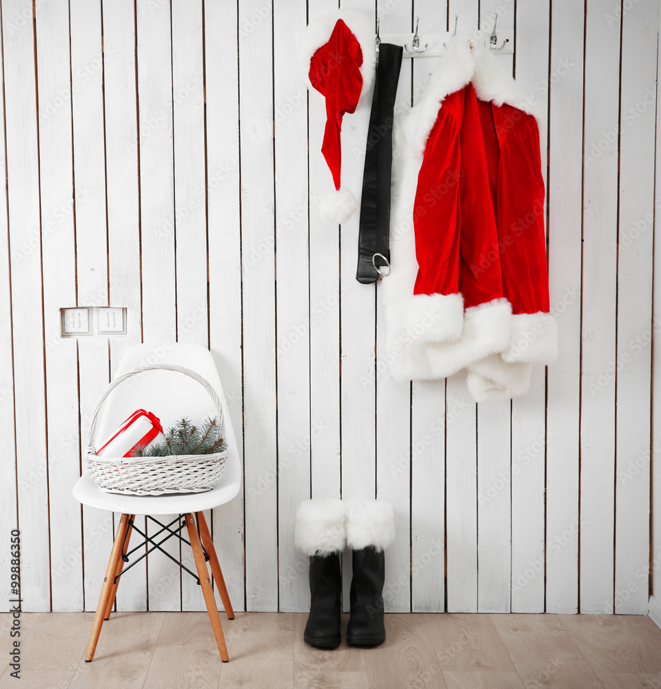 Obraz premium Santa red suit on a wooden white wall