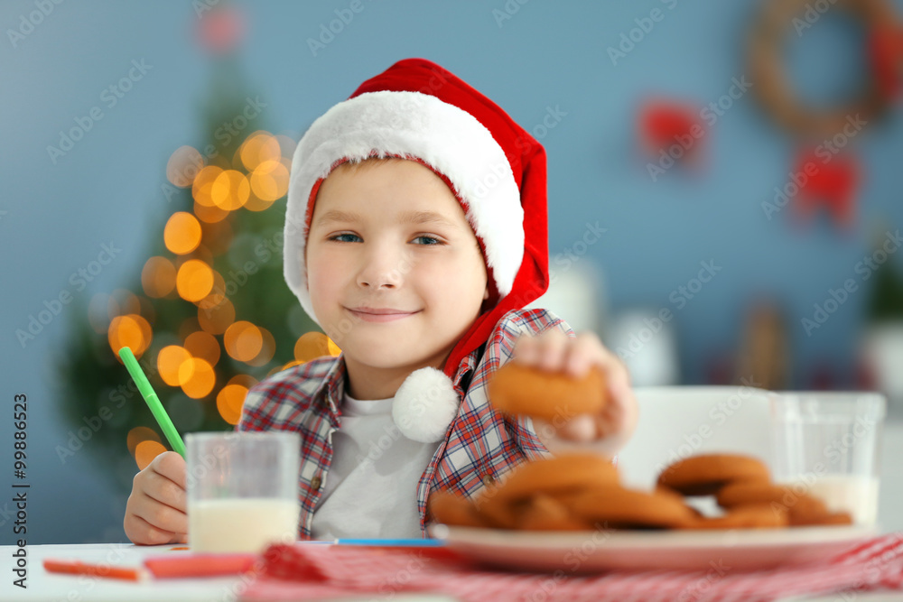 Cheerful boy writing a letter to Santa Claus, close up