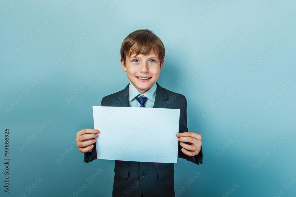 a boy of twelve European appearance in a suit holding a blank a boy of twelve European appearance in a suit holding a blank