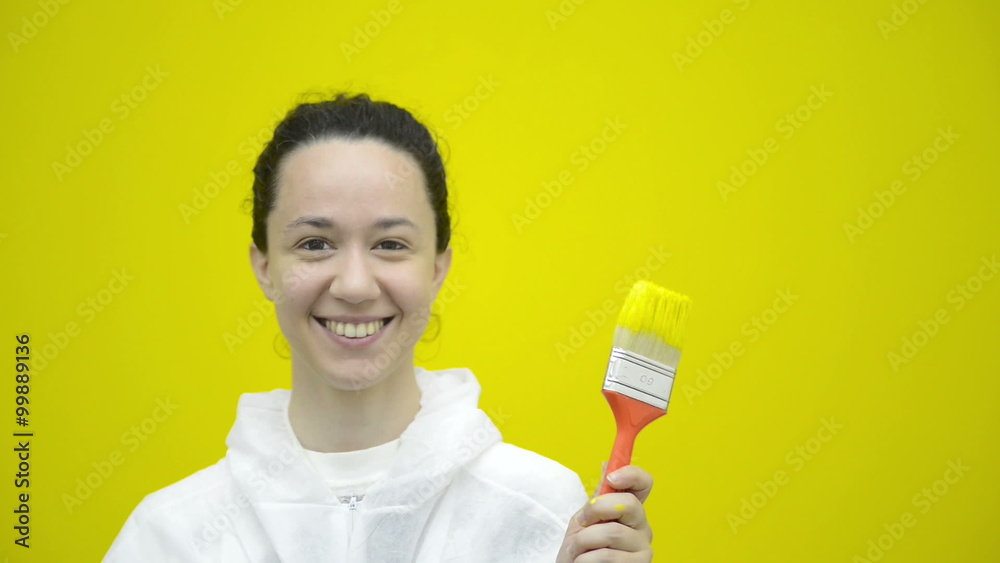 Woman is gesturing with a yellow brush Woman is gesturing with a yellow brush