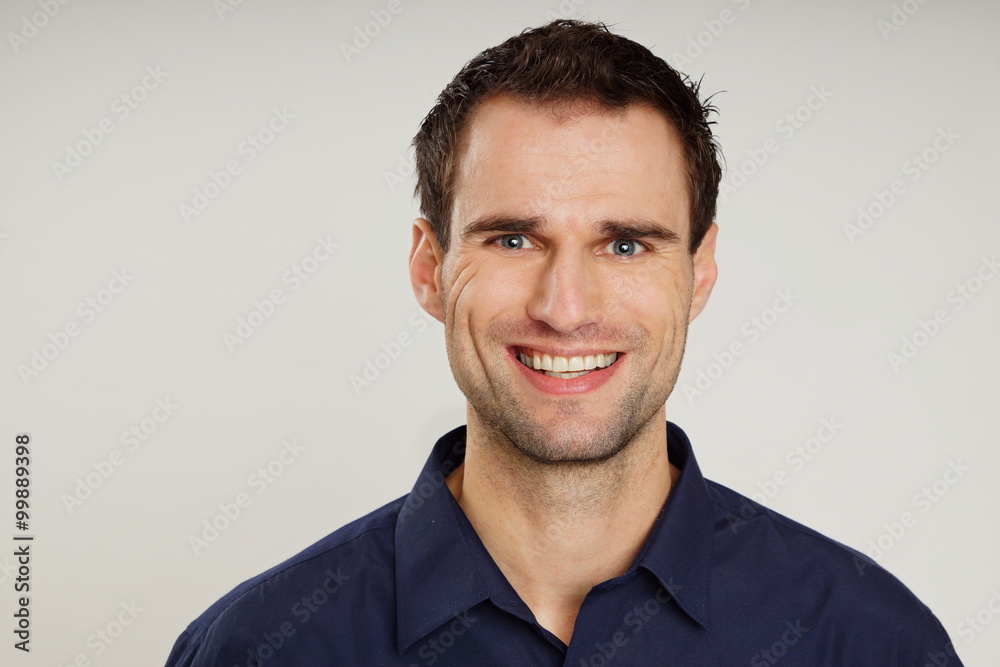Portrait of handsome smiling man in blue shirt