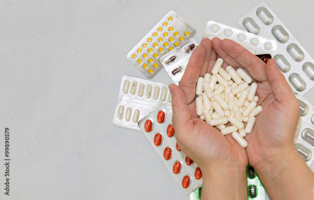 Obraz premium Template with pills in hands and bags of drugs on grey background