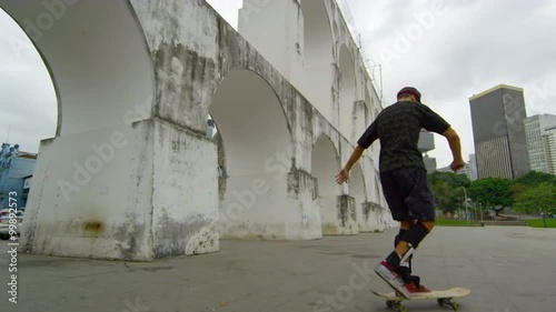 RIO DE JANEIRO, BRAZIL - JUNE 23: Slow dolly shot of skateboarder spins on Jun 23, 2013 in Rio photo