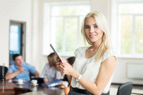 Beautiful smiling young blonde woman with tablet computer in the Free Download Beautiful smiling young blonde woman with tablet computer in the - GFXLoad