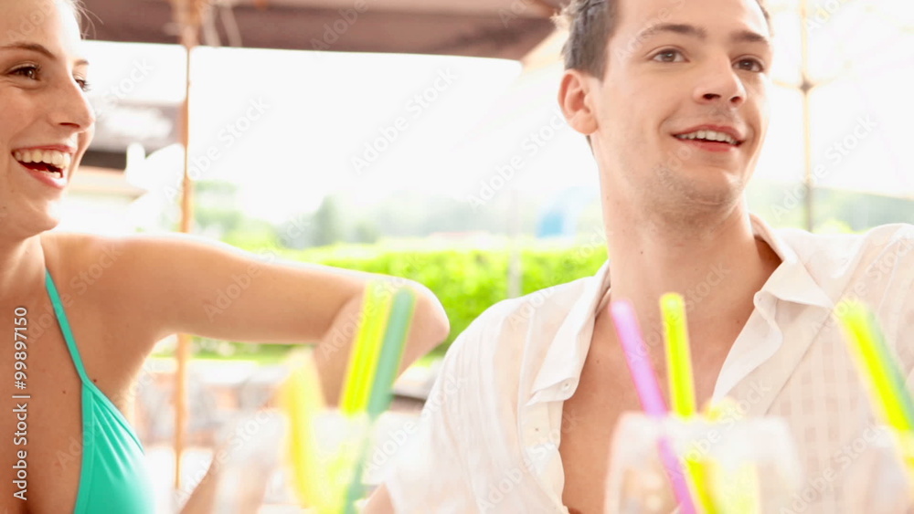 A couple have fun at water park drinking cocktail A couple have fun at water park drinking cocktail