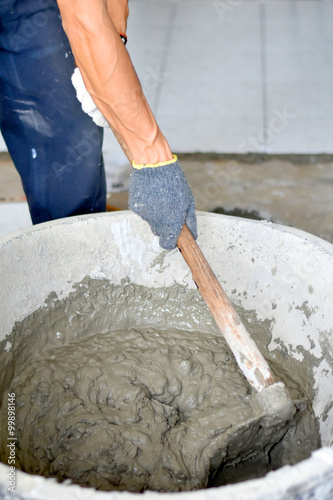 Construction worker mixing cement