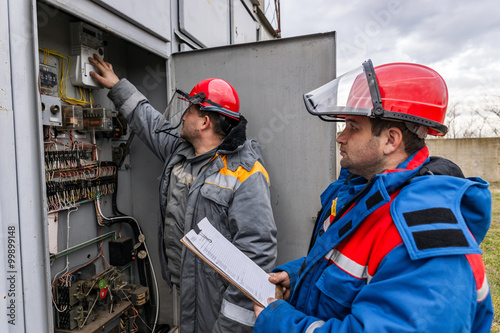Electricians on high voltage substation