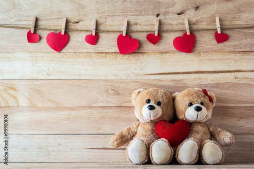 Fotografie The couple Teddy bear holding a heart-shaped pillow