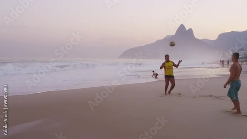 Two men playing sunset soccer on Ipanema beach  photo