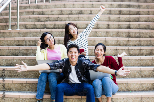 group of happy teen high school students outdoors