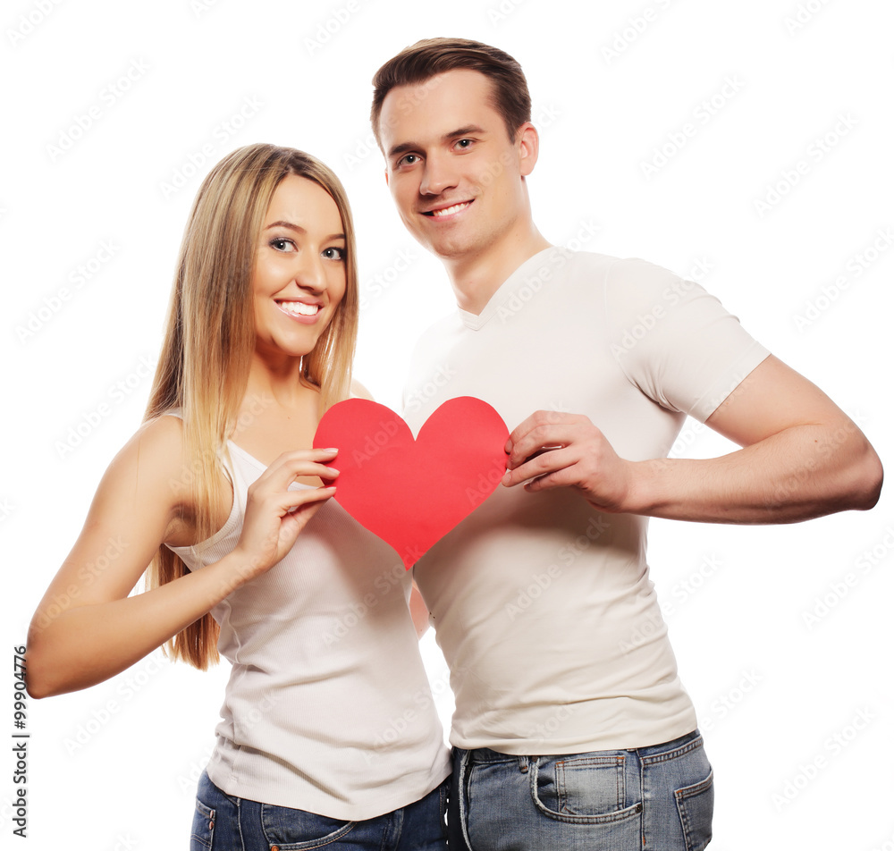 Happy couple in love holding red heart Happy couple in love holding red heart