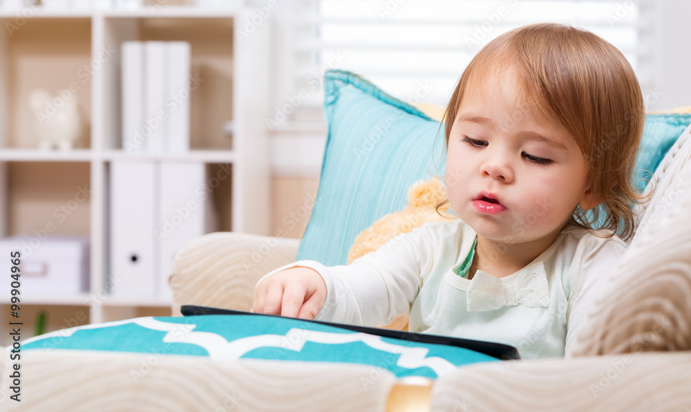 Toddler girl watching her tablet computer Toddler girl watching her tablet computer