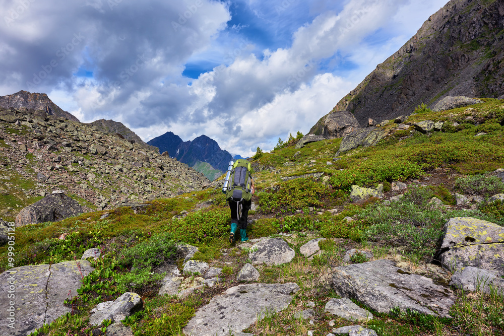 Hiking. Woman walks on a mountain path