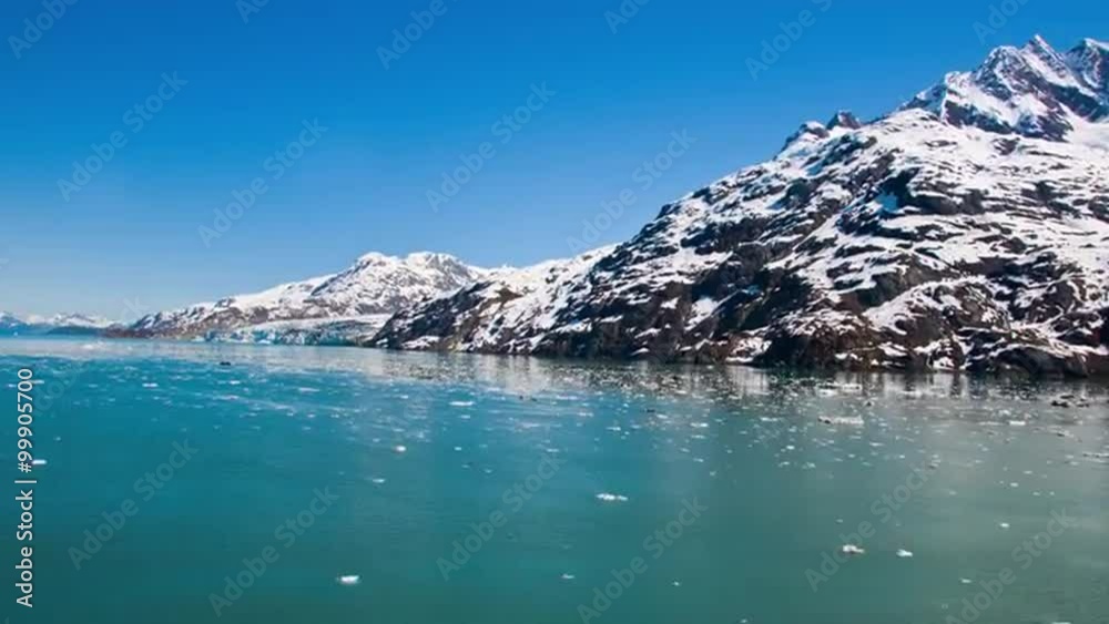 Time lapse of snow capped mountains in Glacier Bay from a cruise ship turning around