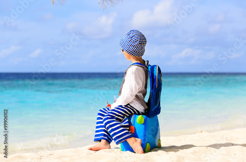 little boy on beach with suitcase, kids travel