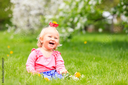cute happy little girl with flowers in spring