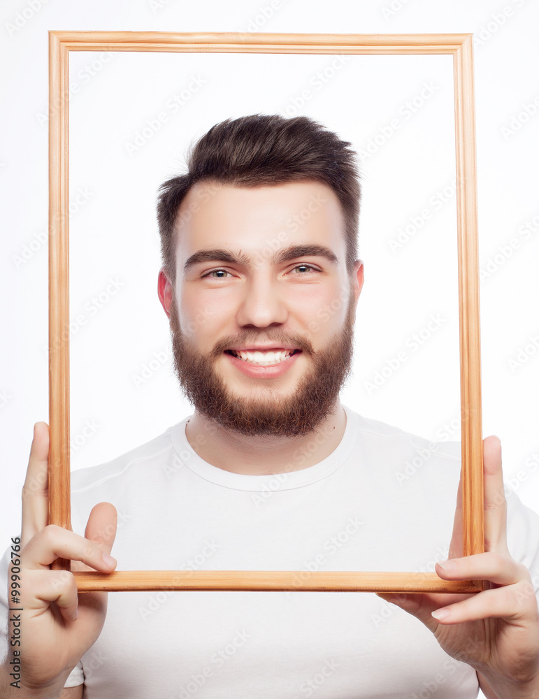 Young man holding picture frame Young man holding picture frame