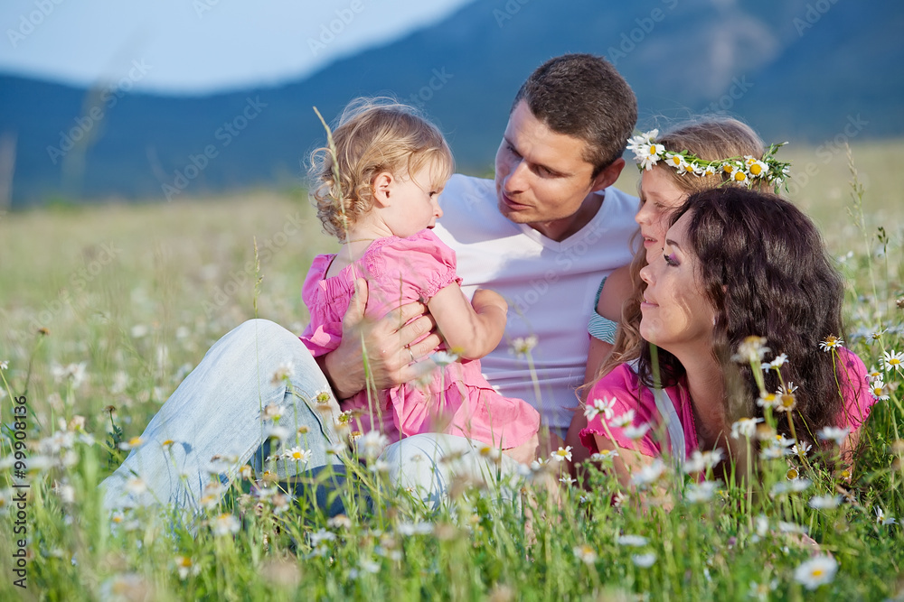 Happy family in a camomile field Happy family in a camomile field