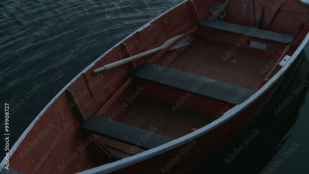 Red wooden rowboat at a dock in Rockport Harbor. Red wooden rowboat at a dock in Rockport Harbor.