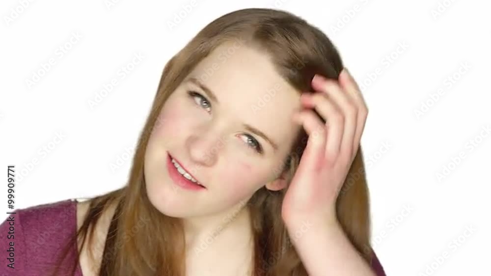 Cute teenager smiling and making silly faces, on a white studio background Cute teenager smiling and making silly faces, on a white studio background