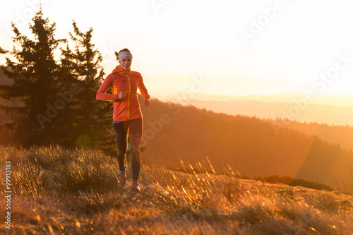 young happy women running in the cold morning with sunshine after sunrise