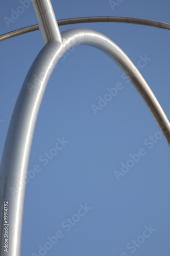 Metal Bar Curve against Blue Sky Background