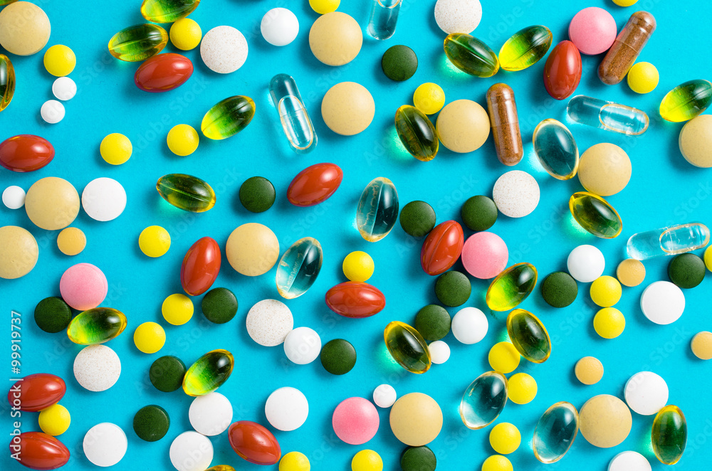 Colorful pills on blue background Colorful pills on blue background
