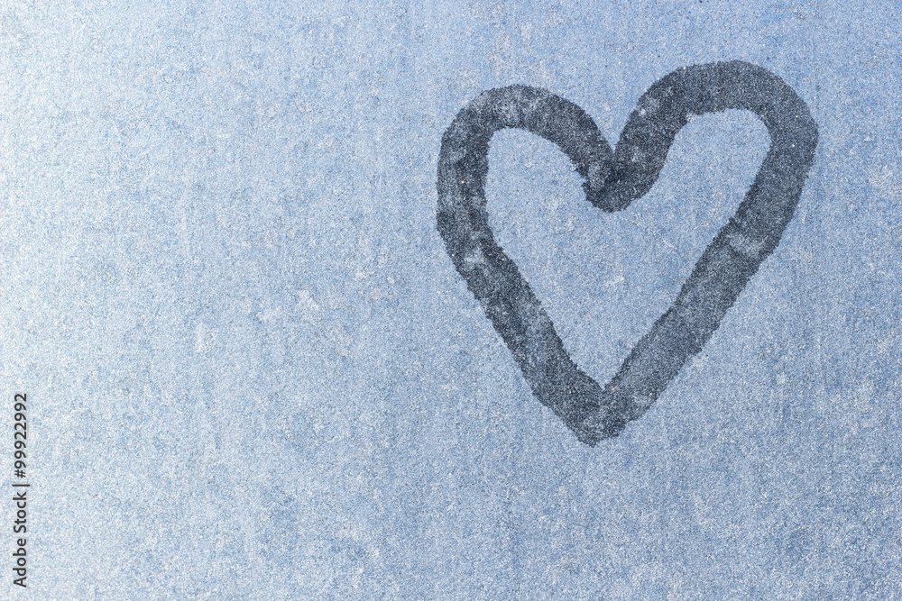Heart on frozen glass. Ice on a window background. Big blue Heart on frozen glass. Ice on a window background. Big blue