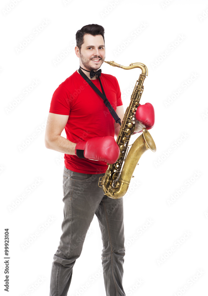 Fototapeta premium man saxophonist in boxing gloves playing saxophone player in st