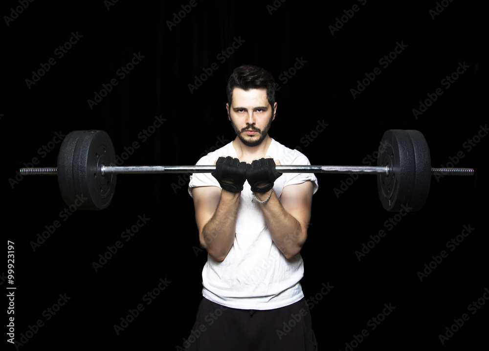 Man doing weight lifting in gym on black background. Close up of Man doing weight lifting in gym on black background. Close up of