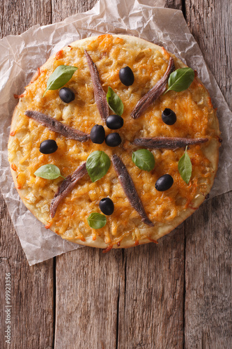 Pissaladiere with anchovies, olives and onion. vertical top view
