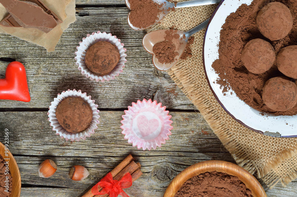Dark chocolate truffles with cocoa powder, biscuit and chopped hazelnuts for loved. Valentines day concept. Top view. Dark chocolate truffles with cocoa powder, biscuit and chopped hazelnuts for loved. Valentines day concept. Top view.