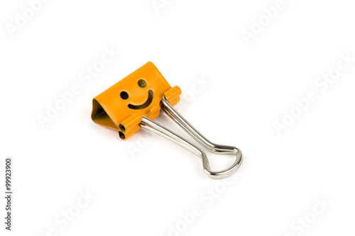 Orange happy face paperclip on white background. 
