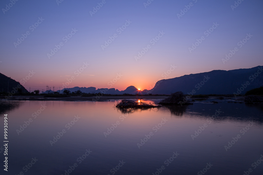 view of sunset and mountain water reflection in gloaming time