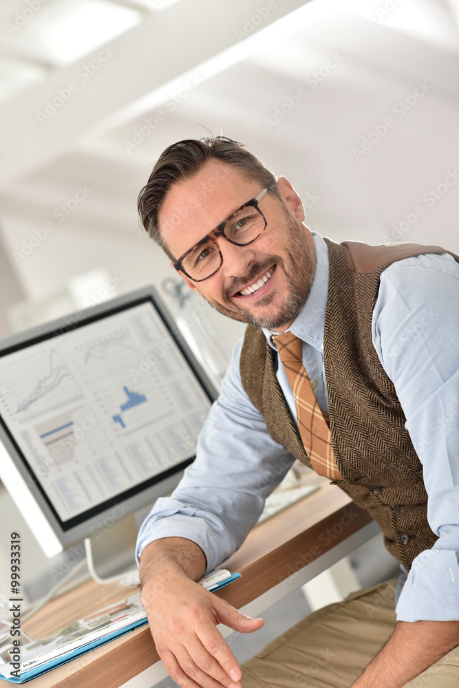 Middle-aged businessman with eyeglasses in office Middle-aged businessman with eyeglasses in office
