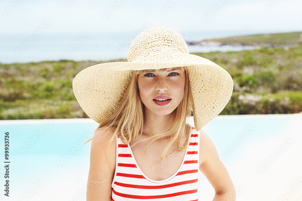 Young woman in swimsuit and sunhat, portrait